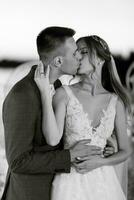 bride and groom against the backdrop of a yellow sunset photo