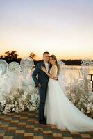 bride and groom against the backdrop of a yellow sunset photo