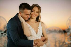 bride and groom against the backdrop of a yellow sunset photo