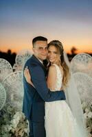 bride and groom against the backdrop of a yellow sunset photo