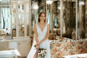 portrait of a bride in a white dress in a bright cafe photo