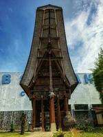 Toba, Indonesia, June 10, 2023 - North Sumatran Toba Batak traditional house, a wooden house of the Batak people that is beautifully preserved at the TB Silalahi Museum photo