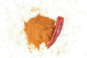 red ground paprika powder or dry chili pepper isolated on white background photo