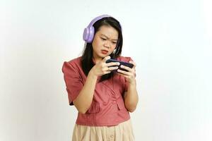 Playing Mobile Game on Smartphone with Headphone Of Beautiful Asian Woman Isolated On White photo