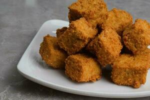 Delicious Fried Tofu On Plate photo