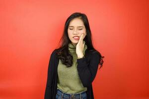 Suffering Toothache Gesture Of Beautiful Asian Woman Isolated On Red Background photo