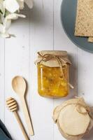 Jar with nuts honey on wooden background top view, flat lay photo