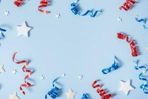 USA Independence day concept. Red, blue and white colors elements of USA flag top view, flat lay on blue background with copy space photo