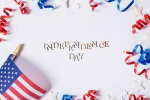 Independence day text. USA flags and Red and blue spirals and white stars top view, flat lay on white background. photo