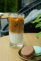 Iced latte coffee in glass on cafe table background. Summer fresh  cold coffe drink photo