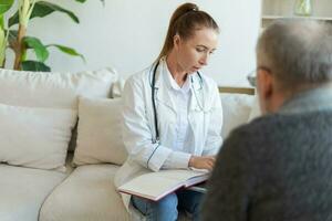 Female doctor examining older senior man in doctor office or at home. Old man patient and doctor have consultation in hospital room. Medicine healthcare medical checkup. Visit to doctor. photo