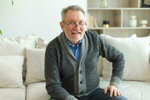 Confident stylish middle aged senior man at home. Older mature 70s man smiling. Happy attractive senior beard grandfather looking camera close up face headshot portrait. Happy people. photo