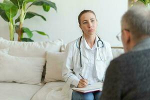 Female doctor examining older senior man in doctor office or at home. Old man patient and doctor have consultation in hospital room. Medicine healthcare medical checkup. Visit to doctor. photo