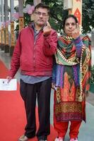 New Delhi, India - December 04 2022 - Unidentified people showing their ink-marked fingers after casting votes in front of polling booth of east Delhi area for MCD local body Elections 2022 photo