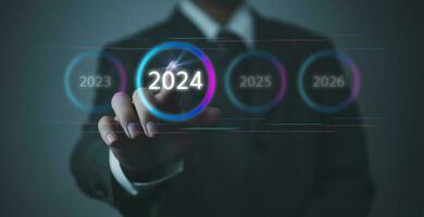 Hand Touching New Goals and Plans on Virtual Screen 2024 and numbers for Next Year Technology Concept photo