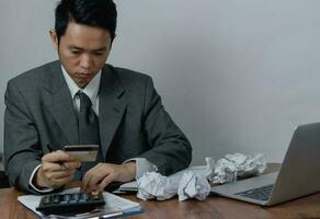 Worried Businessman asian Dealing with Credit Card Debt and Financial Problems checking wallet and credit card statements. Business banking , payment shopping and saving money concept. photo