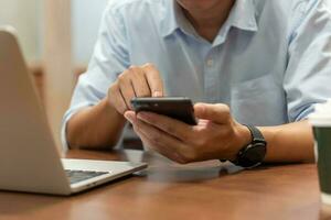 Man using touchscreen smartphone to stay connected, browse the internet, access information, and engage with social media. photo