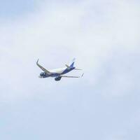 New Delhi, India, April 16 2023 - Indigo Airbus A320 take off from Indra Gandhi International Airport Delhi, Indigo domestic aeroplane flying in the blue sky during day time photo