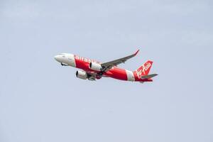 New Delhi, India, April 16 2023 - Air Asia Airbus A320 take off from Indra Gandhi International Airport Delhi, Air Asia domestic aeroplane flying in the blue sky during day time photo