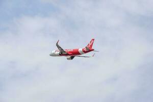 New Delhi, India, April 16 2023 - Air Asia Airbus A320 take off from Indra Gandhi International Airport Delhi, Air Asia domestic aeroplane flying in the blue sky during day time photo