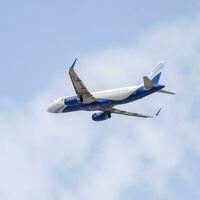 New Delhi, India, April 16 2023 - Indigo Airbus A320 take off from Indra Gandhi International Airport Delhi, Indigo domestic aeroplane flying in the blue sky during day time photo