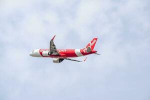 New Delhi, India, April 16 2023 - Air Asia Airbus A320 take off from Indra Gandhi International Airport Delhi, Air Asia domestic aeroplane flying in the blue sky during day time photo