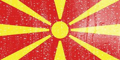 3D Flag of North Macedonia on a glass with water drop background. photo