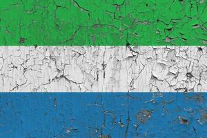 3D Flag of Sierra Leone on an old stone wall background. photo