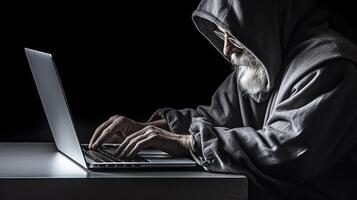 Closeup Portrait of Aged Man in Grey Hoodie Jacket and Using Laptop. Concept of Hacker or Cyber Security Concept. . photo