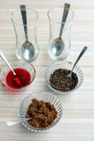 Ingredients of sundae dish as a part of non fire cooking which includes vanilla ice cream, brownie, coco powder, freshly chopped fruits and strawberry syrup. Preparation of sundae dish photo