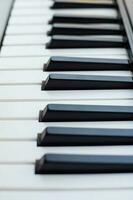 Close-up of piano keys. Piano black and white keys and Piano keyboard musical instrument placed at the home balcony during sunny day. photo