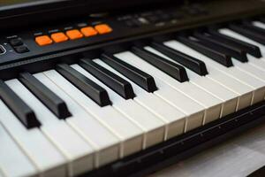 Close-up of piano keys. Piano black and white keys and Piano keyboard musical instrument placed at the home balcony during sunny day. photo