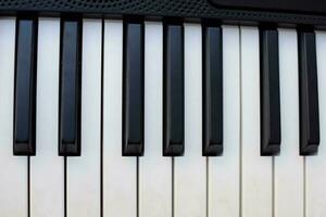 Close-up of piano keys. Piano black and white keys and Piano keyboard musical instrument placed at the home balcony during sunny day. photo