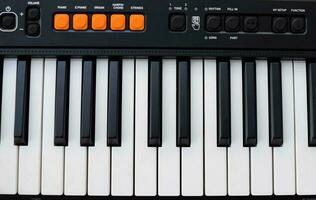 Close-up of piano keys. Piano black and white keys and Piano keyboard musical instrument placed at the home balcony during sunny day. photo