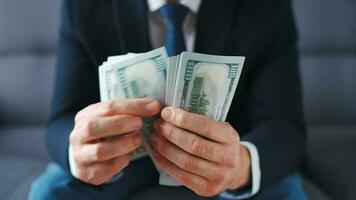 Formally dressed man counting US Dollar bills, close-up. video