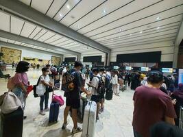 Jakarta, Indonesia on May 21, 2023. People are queuing at the check-in counter in Terminal 2F of Soekarno Hatta Airport CGK photo