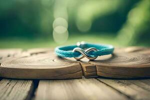 a close up photograph of a pair blue bracelet forming an infinity symbol on a rustic wood with bokeh background photo