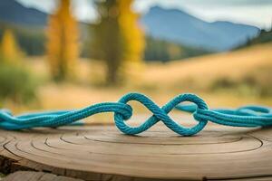 un cerca arriba fotografía de un par azul pulsera formando un infinito símbolo en un rústico madera con bokeh antecedentes foto