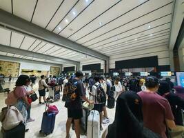 Jakarta, Indonesia on May 21, 2023. People are queuing at the check-in counter in Terminal 2F of Soekarno Hatta Airport CGK photo
