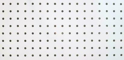 Seamless pattern of polka dot on white stainless steel for background. Art Wallpaper and Textured concept. photo