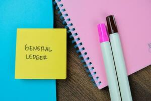 Concept of General Ledger write on sticky notes isolated on Wooden Table. photo