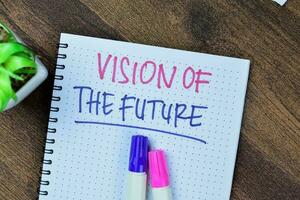 Concept of Vision Of The Future write on book isolated on Wooden Table. photo