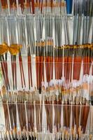 Paintbrushes on display for sale in art store. School stationery, office supply shop. Visual arts, painting, creativity photo