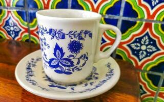 Blue white cup pot with black coffee wooden table Mexico. photo