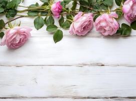 round frame wreath pattern with roses, pink flower buds, branches and leaves isolated on white background. flat lay, top view created with technology. photo