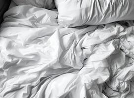 Top view of unmade bedding sheets and pillow ,Unmade messy bed after comfortable sleep concept created with technology. photo