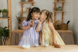 little happy girls fool around in the spring and cook in the kitchen photo