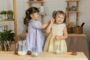 little happy girls fool around in the spring and cook in the kitchen photo