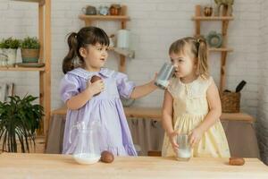 little happy girls fool around in the spring and cook in the kitchen photo