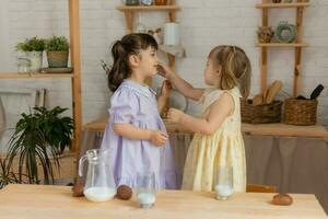 little happy girls fool around in the spring and cook in the kitchen photo